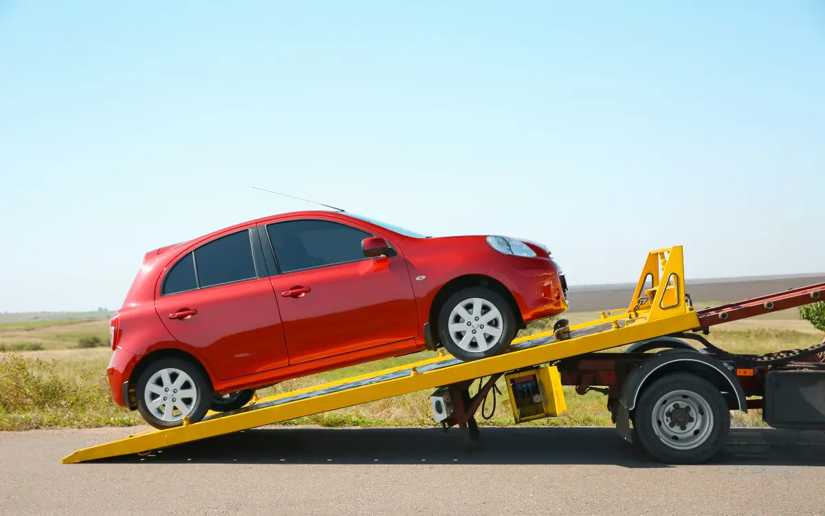 Flatbed truck pulls a car